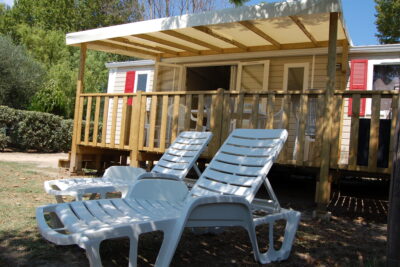 Jardin d'un mobil-home EVO équipé de deux chaises longues à l'ombre - Agrandir l'image 1 sur 10, fenêtre modale