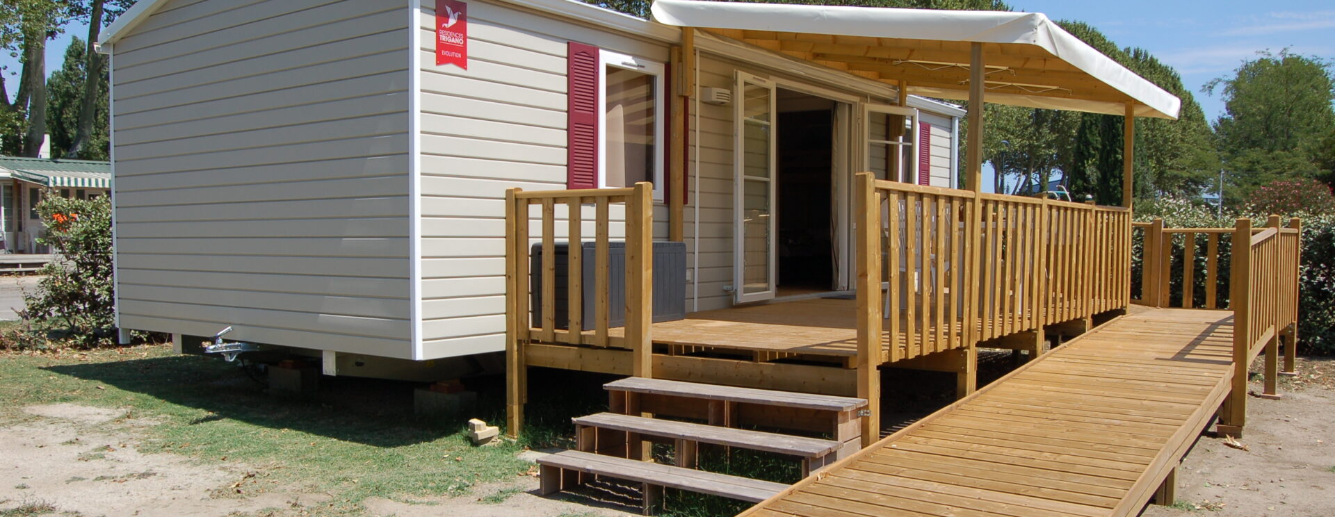 Mobil-home Optiméo accessible aux personnes à mobilité réduite notamment grâce à sa rampe d'accès et à ses volumes spécialement conçus pour.